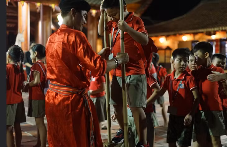 Tourists are instructed to walk on stilts.