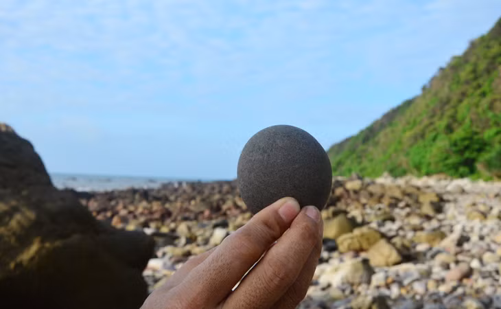 Moon-shaped rock on the beach