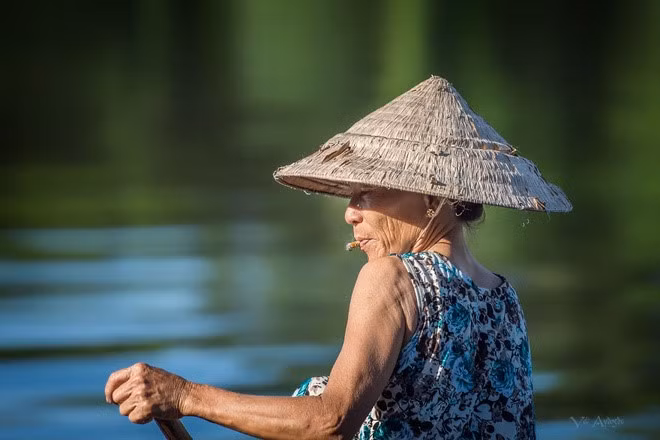 Woman on Perfume River in Hue by Veli Aydogdu