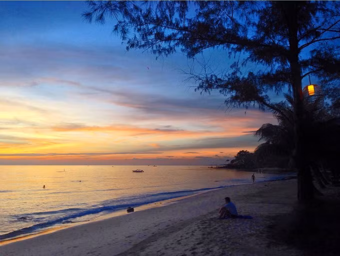  A tourist sits on the smooth sands of Ong Lang Beach in Phu Quoc at sunset. Photo by Leonievits