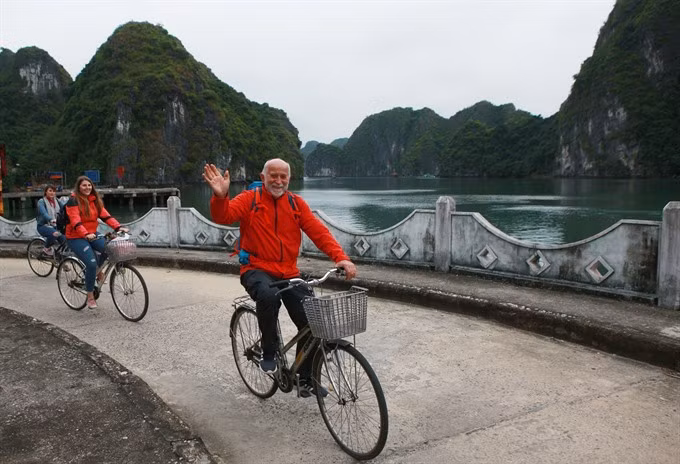 Visitors ride bicycles on Cat Ba Island in the northern province of Hai Phong. Viet Nam received a record 12.9 million foreign visitors in 2017. 