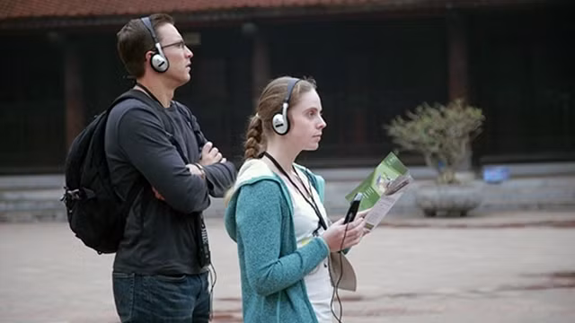 Visitors using automatic interpretation services at the Van Mieu - Quoc Tu Giam (The Temple of Literature) relic