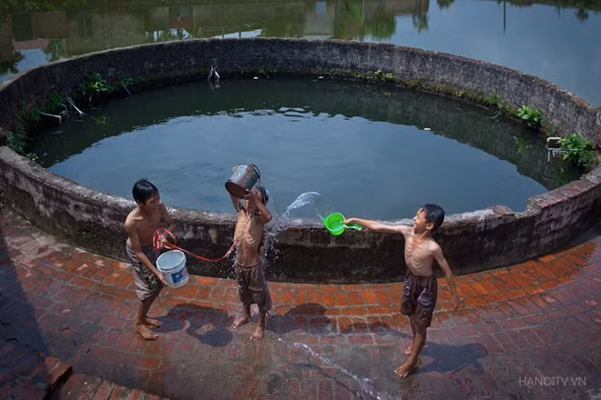 Boys bathe beside village well