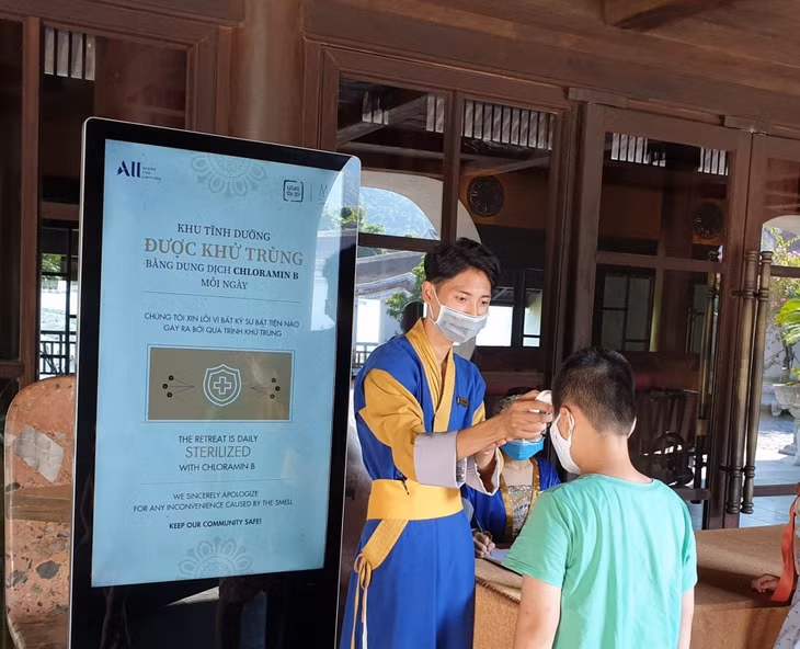 A visitor to A staff of Yen Tu Legacy resort had his body temperature measured is measuring temperature for visitors before check-in procedures.