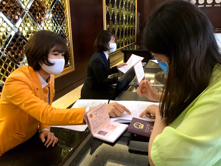Receptionists at Royal Ha Long Hotel help tourists to make health declaratio
