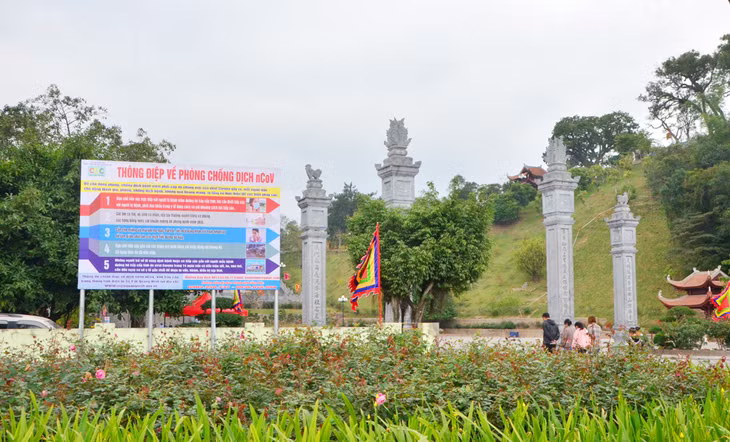 The poster printed with notice about the disease is placed at the entrance of Cua Ong Temple