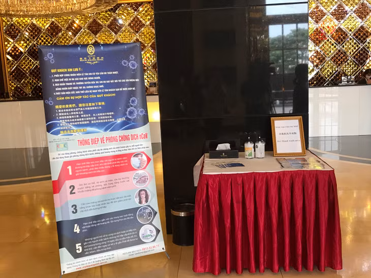 Poster on Covid-19 disease and hand sanitizer gel area placed at the entrance of the hotel