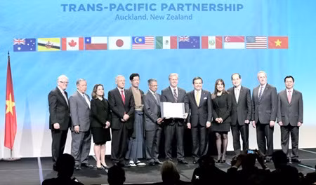 Commercial and Trade Ministers from Trans-Pacific Partnership member countries pose for a group photo at the signing ceremony in Auckland, New Zealand yesterday.— AFP/VNA Photo