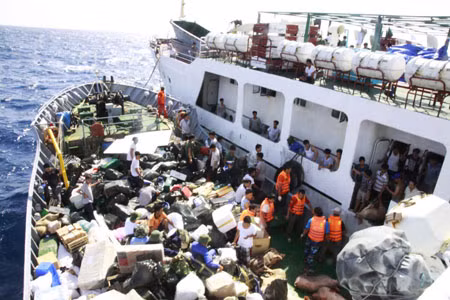 Moving the goods and Tet gifts to the boat to take to the island