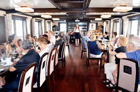 Nga (in the middle) introduced tour program to the tourists on the cruise