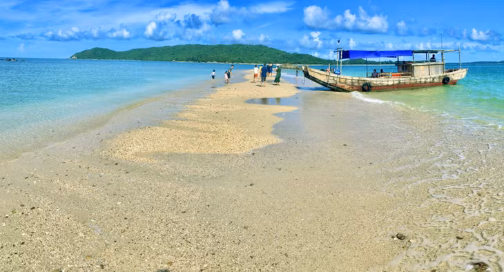 A green, peaceful oasis with long stretches of golden sand, clear blue water which seems sparkling under the sun.