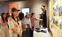 Tourists view the exhibition space at the San Diu Ethnic Cultural-Tourism Village.