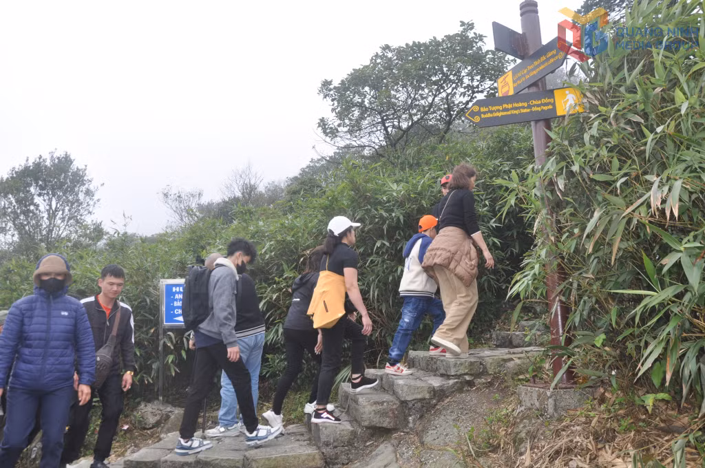 Pilgrims walk along forest trails within Yen Tu National Forest.