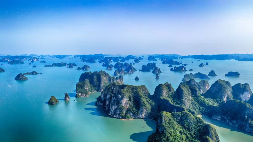 According to Condé Nast Traveler, Ha Long Bay is beloved for its blue waters and spread of limestone islands, all occupied by tropical trees and wildlife.