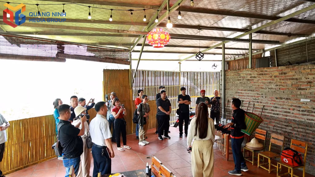 A Japanese expert delegation listens as a local guide introduces traditional forest-travel tools.