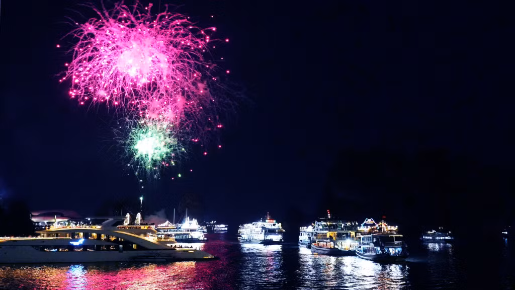 Vibrant music, multicolored lighting effects and fireworks from the decks transform the night bay into a giant floating stage.