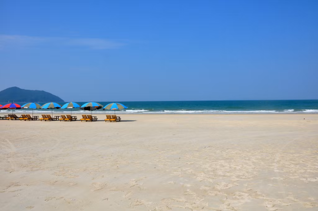 Tourists are impressed with smooth white sand beach and clear blue water.