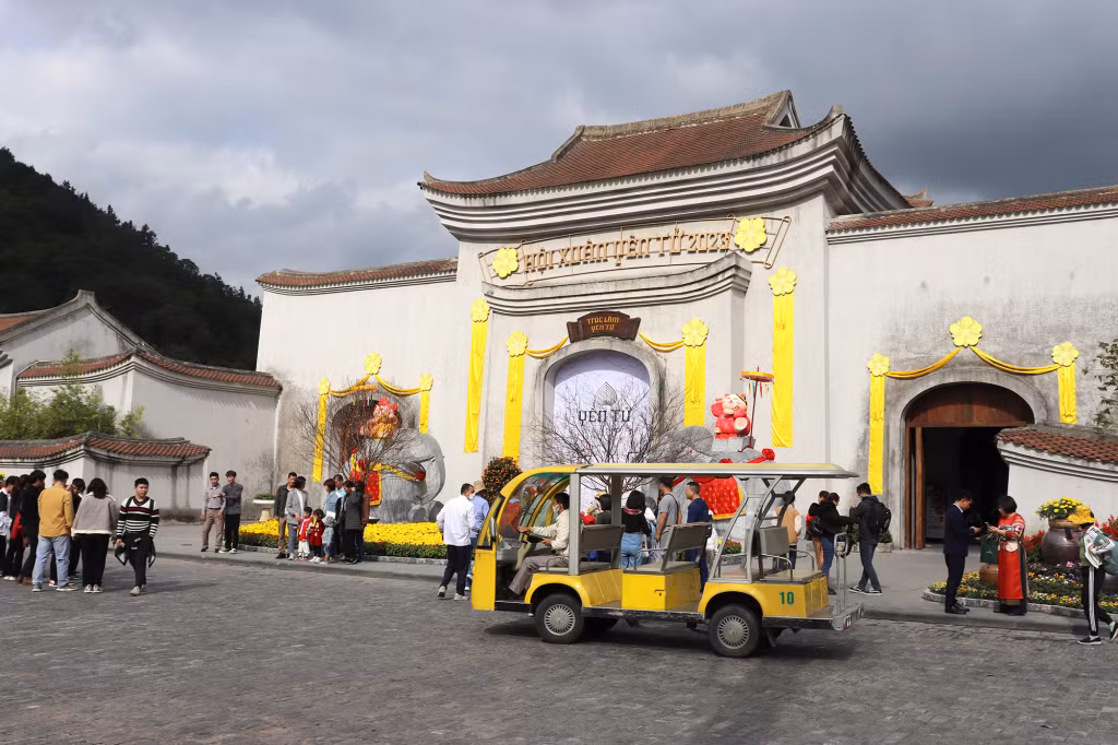 The "Khai Tam" gate is decorated with flowers and flags.