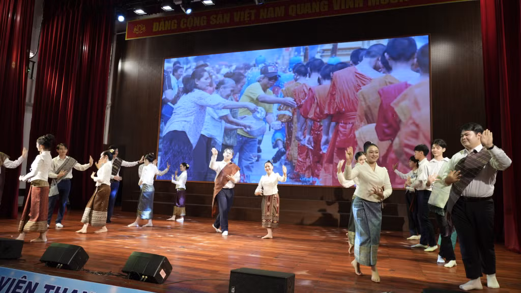 Lao students recreate the Lam Vong dance and the traditional water-splashing ritual.
