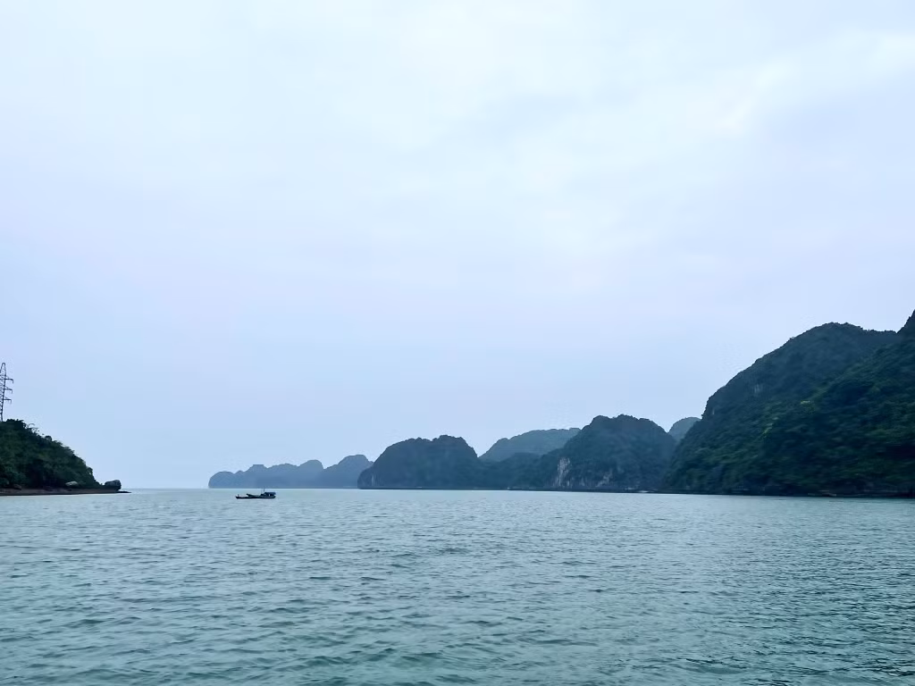 The flat landscape of Mang Ha waters stretches to the horizon.