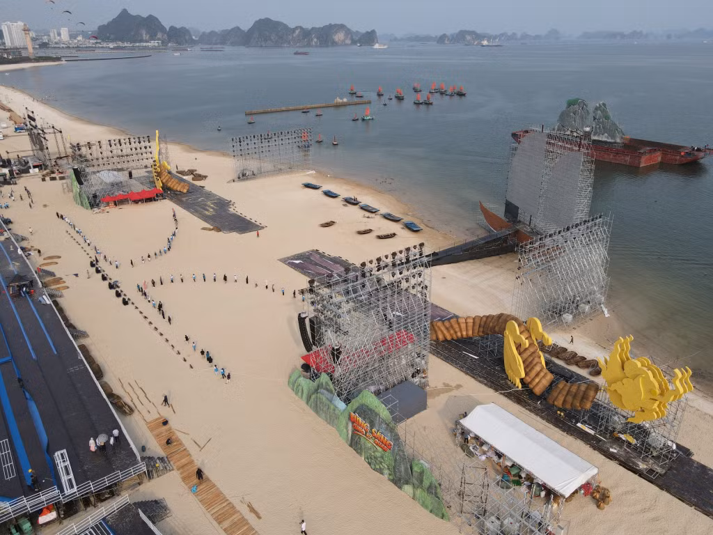 People prepare for their performances at the area of the main stage close to the bank of Ha Long Bay