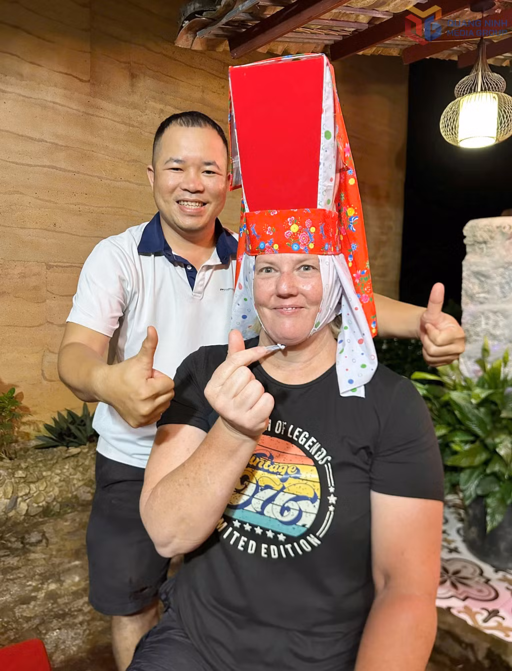 Kristy Shooter, a visitor from Australia, tries on a traditional Dao Thanh Phan women’s headdress during her trip to Binh Lieu, Luc Hon and Hoanh Mo communes in July 2026.