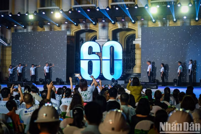 Delegates perform the symbolic gesture of turning off the lights, in response to the Earth Hour campaign.