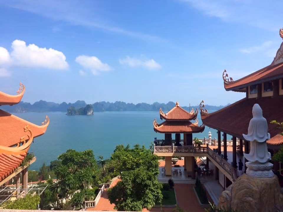Cai Bau Pagoda is nestled against a mountain range and faces Bai Tu Long Bay