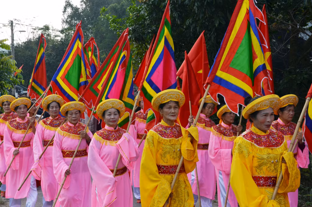 Impressive traditional ritual of offering at Ngoc Vung Shrine ảnh 7 Đội rước cờ thần của các nữ phụ lão tham gia đoàn rước.