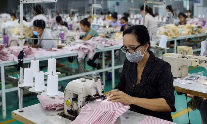 Employees of a garment firm in the southern province of Long An work. 