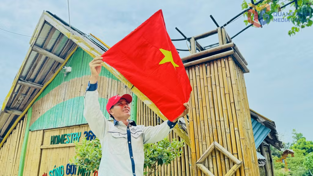 A resident living in Co To Special Zone flies the national flag in celebration of the 14th National Party Congress