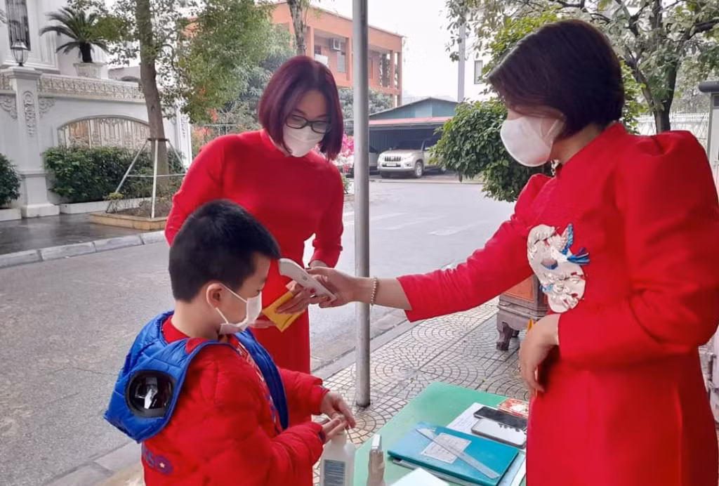Teachers welcome students right from the school gate, measure their temperature and instruct them to wash their hands with sanitizer.
