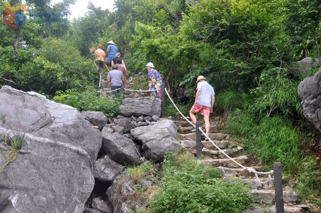 Co cave is nestled halfway up Hon Co island, with a staircase path leading visitors to its entrance.