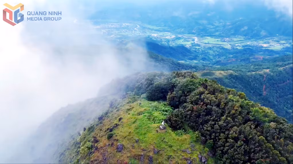 The majestic peak of Cao Xiem stands shrouded in mist and clouds, creating a scene of ethereal beauty.