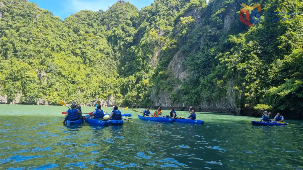 The crystal-clear lagoon nestled within Luon cave, embraced by lush greenery, offers an idyllic setting for kayaking and quiet relaxation, an inviting retreat in the heart of Ha Long Bay.