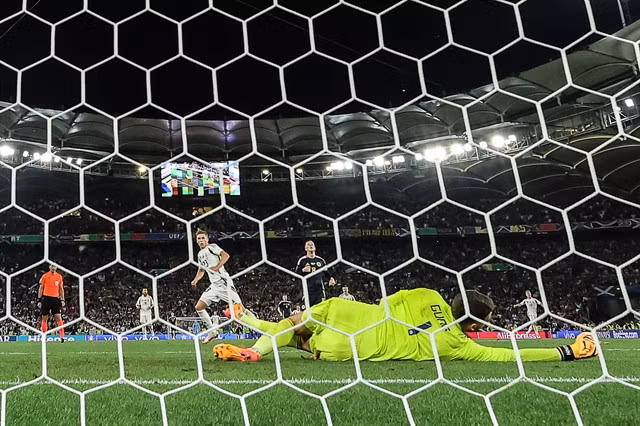 Hungary forward Kevin Csoboth (left) scores against Scotland.