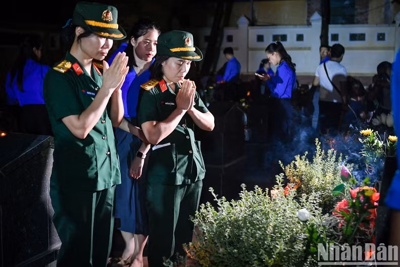 Members of the armed forces pay tribute to the fallen soldiers.