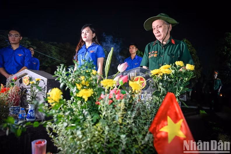 Relatives of martyrs are present at the cemetery to commemorate the fallen.
