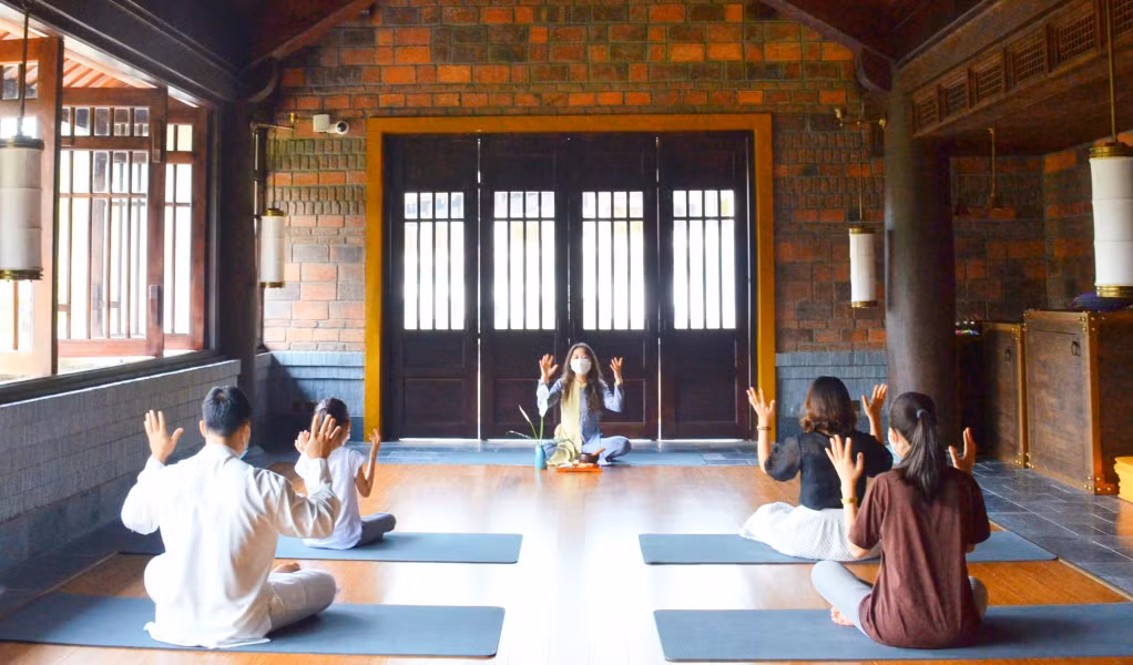 Tourists take part in meditation and yoga classes at Yen Tu Legacy.