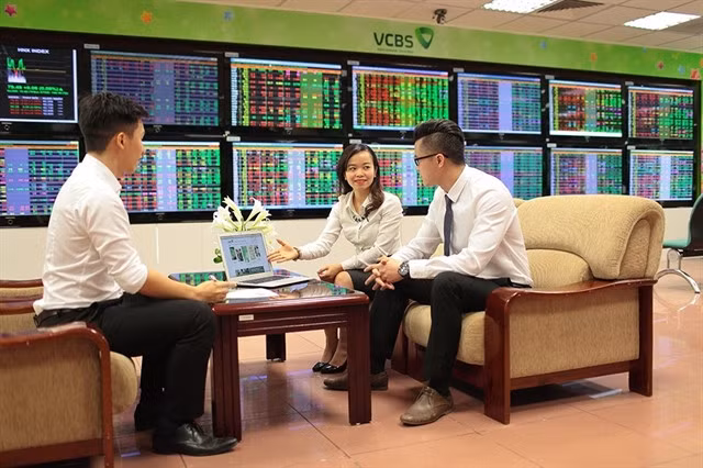 Investors study the market at the Vietcombank Securities Company. — Photo courtesy of Vietcombank Securities