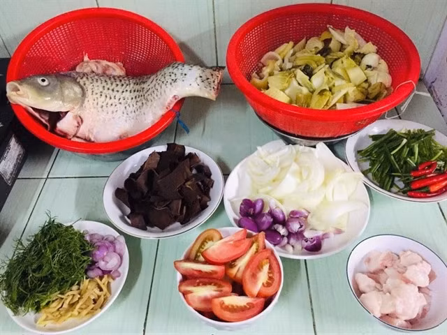 Ingredients include carp, pickles, tomato, fresh herbs, chilli and others. — Photo tastykitchen.vn