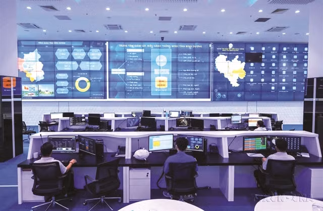 SMART MOVES: The Intelligent Operation Centre of Bình Dương Province (now part of the enlarged HCM City), tasked with monitoring, supervising and managing activities in several key areas such as ensuring security, traffic control, smart transport and emission control. The government plans that by 2030, Việt Nam will have at least five major projects in the fields of artificial intelligence, semiconductor technology, smart factories, and smart cities. VNA/VNS Photo Hoàng Hiếu