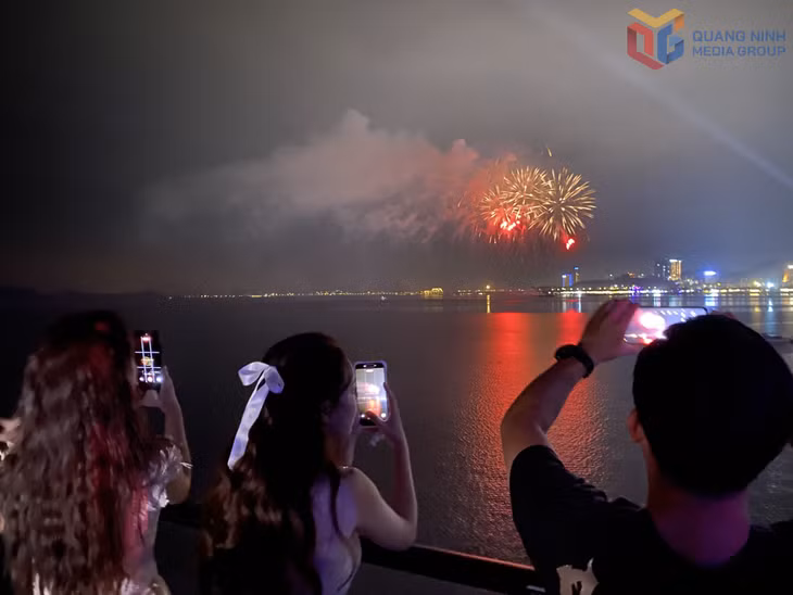Tourists watch fireworks displays from cruise ships.