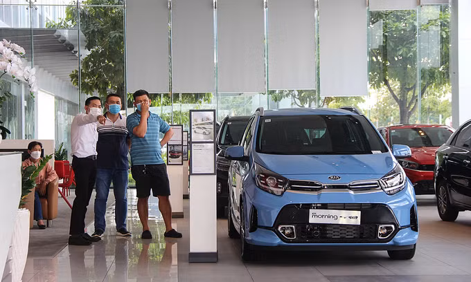 Customers view cars at a dealer in southern Vietnam. 
