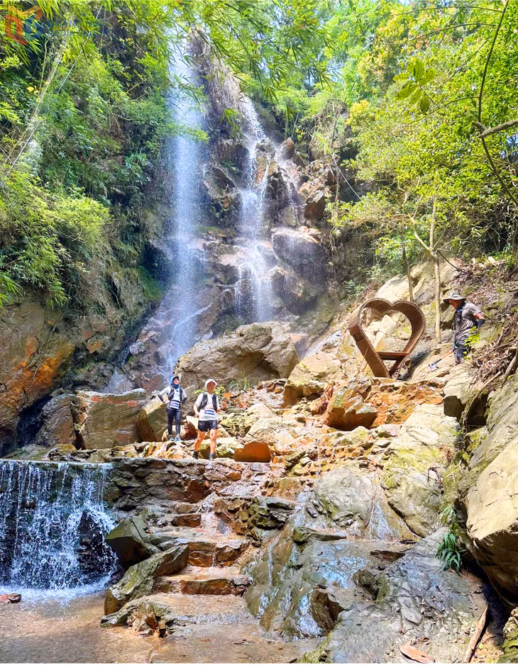 Visitors explore Bac Waterfall in Yen Tu Ward.