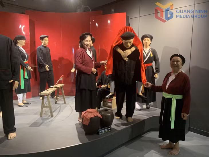 Artisans carefully review the traditional attire showcased at the San Diu Cultural and Tourism Village.