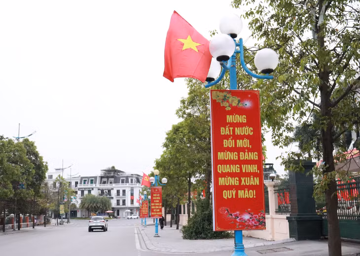 Red banners welcoming the Lunar New Year are hung on the light posts along many streets.
