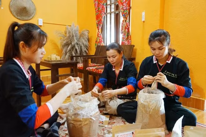 Huong (middle) and her staff packaging herbal products derived from ancient Dao remedies in Yen Tu