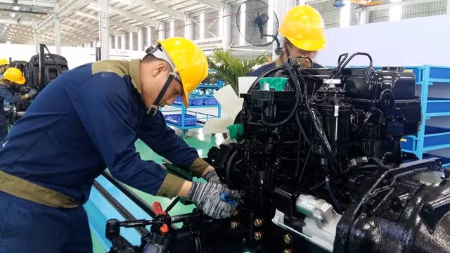 Workers check an engine on a mechanical production line at the Trường Hải Mechanical Automobile Industries Zone in Quảng Nam Province. The central province will target economic growth of 9.5 to 10 per cent in 2025. — VNS Photo Công Thành