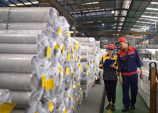 Workers at a firm in Hà Nội. Businesses are seeing positive changes from the two-tier local government system. — Photo baotintuc.vn